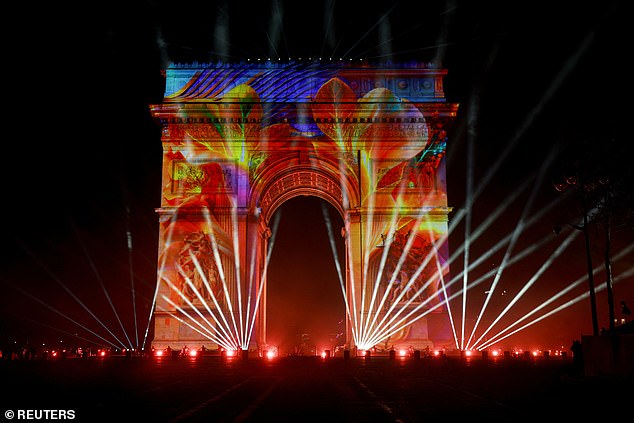 An image is projected onto the Arc de Triomphe, during the New Year's celebrations on the Champs Elysees avenue