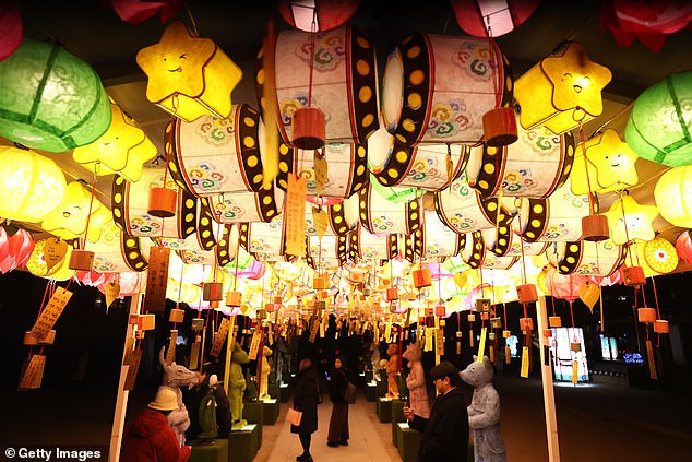 Members of the public gather to celebrate New Year's Eve at the Jogyesa buddhist temple in Seoul, South Korea