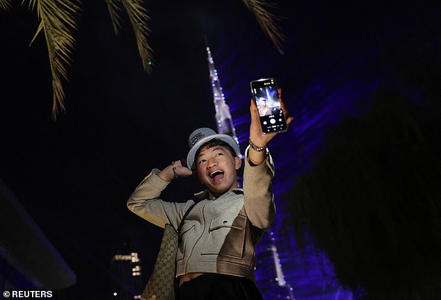 A person takes a selfie during New Year's celebrations in Dubai, United Arab Emirates