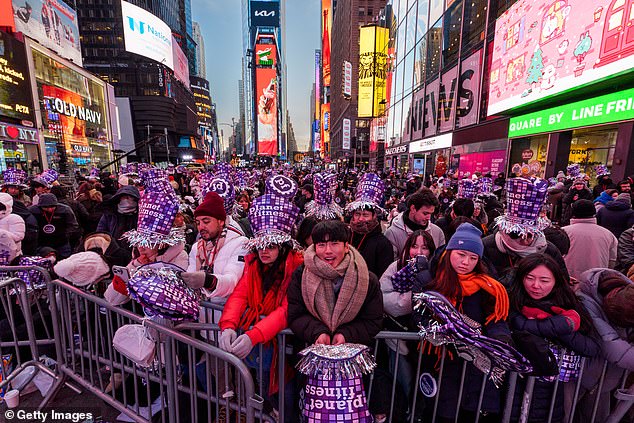 People wait in Times Square ahead of New Year's Eve celebrations on December 31
