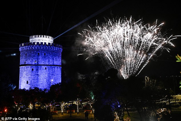 Fireworks explode over Thermaikos gulf next to the White Tower on January 1, 2026