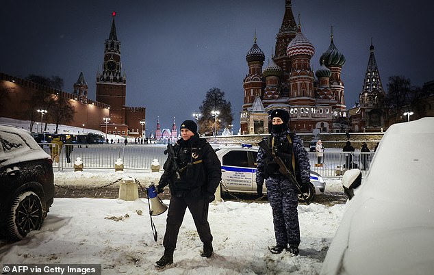 Law enforcement officers guard the closed Red Square during the New Year's Eve celebrations in Russia's capital city
