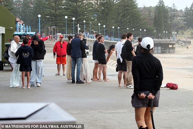 Locals at Coogee are seen after a man went missing in the surf about 6am on Thursday