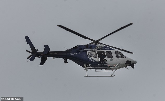 A helicopter is seen searching for a missing man at Coogee Beach