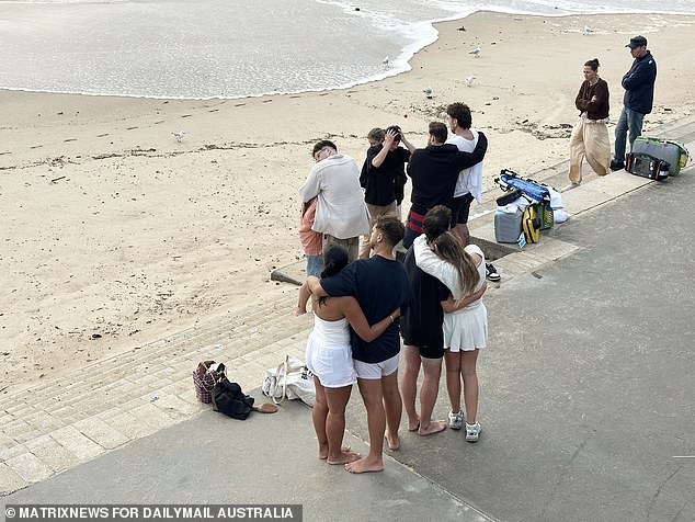 People were seen embracing at the water's edge as the search for the man continued
