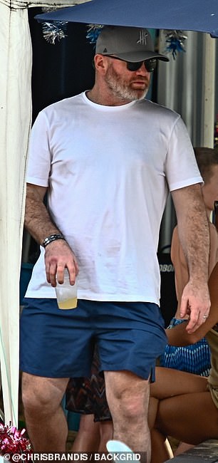 Wayne completed the look with blue shorts