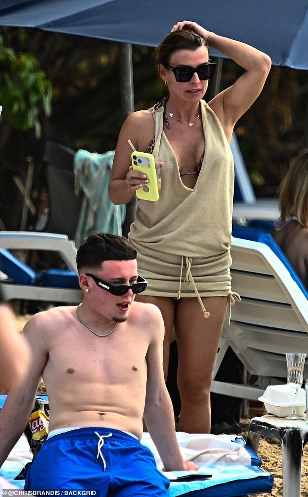 Coleen looked sensational in the halter neck beach cover up
