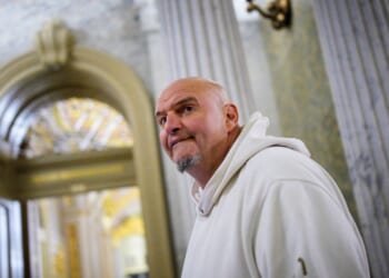 Sen. John Fetterman, one of eight Democrats to say he will vote with Republicans to open the government, arrives for votes on Nov. 10, 2025, on Capitol Hill in Washington, D.C.