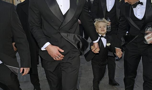 Adam Peaty has arrived at his wedding hand in hand with his adorable son George as he prepares to marry Holly Ramsay at Bath Abbey on Saturday