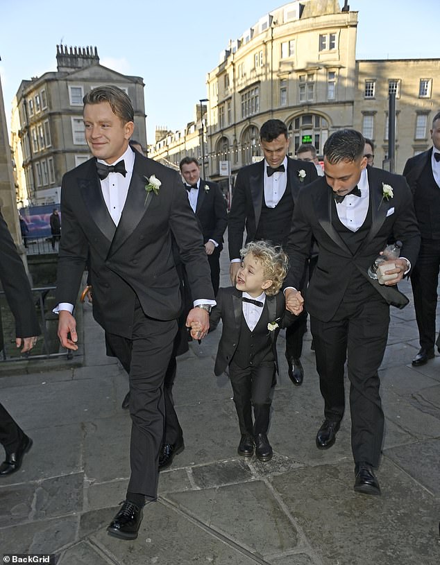 The gold medalist, 30, arrived ahead of the ceremony appearing calm, cool and collected, wearing a smart black suit as he clung on to his five-year-old son, George's hand