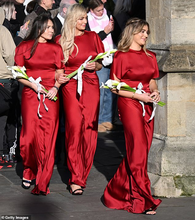 In what was seen by some as a display of defiance against her family, Bethany linked arms with Holly's eldest sister as they entered the abbey carrying white arum lilies