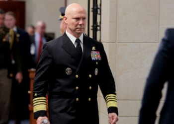 Navy Adm. Frank Bradley walks to a hold room between closed-door classified meetings with lawmakers on Capitol Hill on Thursday in Washington, DC. Members of the Senate and House Armed Services committees met with Bradley about the strikes on suspected drug boats out of Venezuela ordered by the Trump Administration.