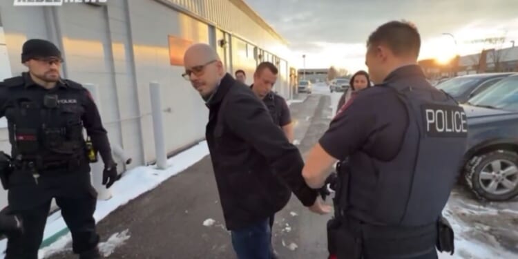 Canadian police arrest Pastor Derek Reimer for refusing to write a letter of apology to a librarian for disrupting a drag-queen story hour event.