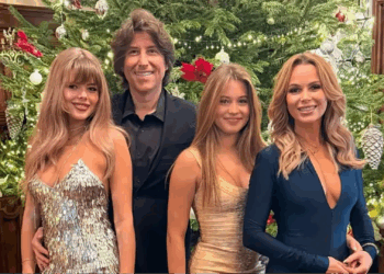 Amanda Holden wows in a plunging dress with lookalike daughters as they ring in the New Year with Alan Carr