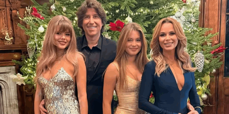 Amanda Holden wows in a plunging dress with lookalike daughters as they ring in the New Year with Alan Carr