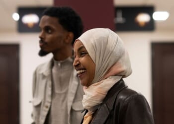 Rep. Ilhan Omar, a Democrat from Minnesota, laughs as she campaigns with Minneapolis mayoral candidate State Senator Omar Fateh on Election Day at the University of Minnesota on Nov. 4, 2025, in Minneapolis, Minnesota.