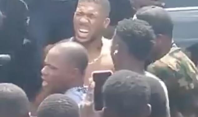 Joshua pictured after the car crash in Nigeria on Monday which killed two people. The star came within inches of death in the crash