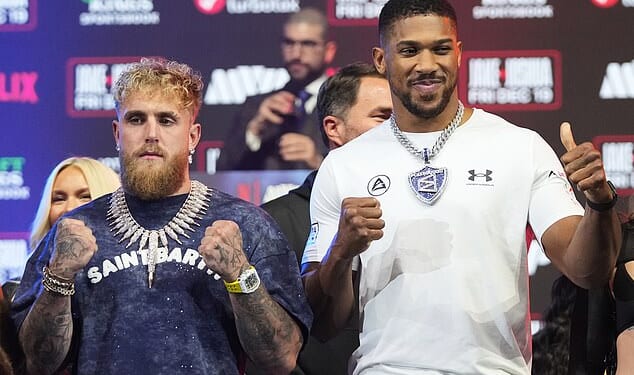 Jake Paul, left, and Anthony Joshua face-off during a news conference promoting their upcoming heavyweight boxing match, Wednesday, Dec. 17, 2025, in Miami Beach, Fla. (AP Photo/Lynne Sladky)