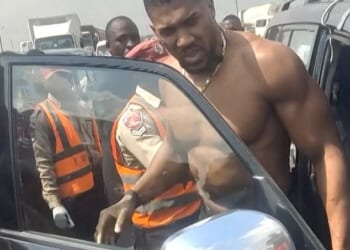 Anthony Joshua being moved from a Lexus after a car crash in Nigeria. He escaped death on Nigeria's deadliest road where 73 people have died in just three months