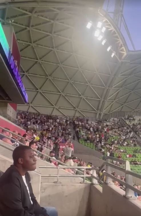 Barmy Army supporters watching a sporting event from the stands.