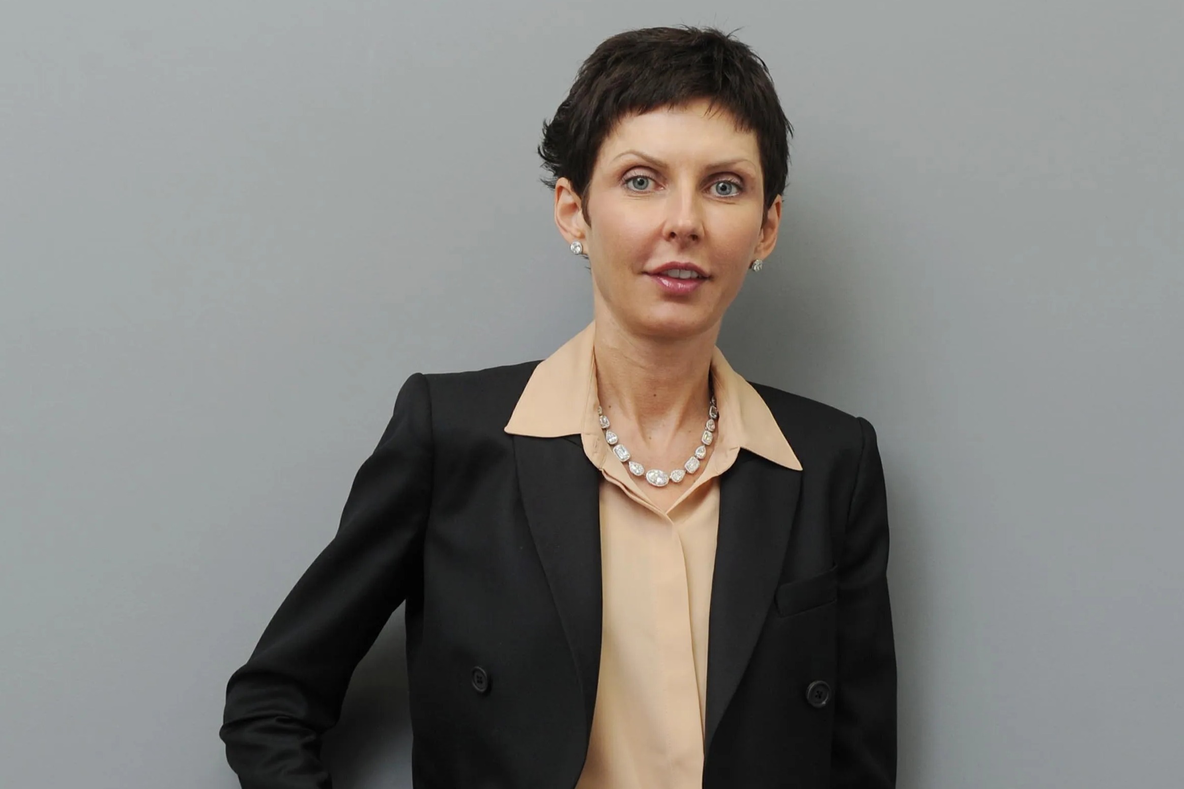 Denise Coates, Bet365 boss, in front of a Bet365 sign.