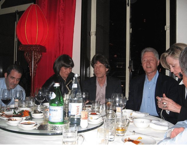 Another photo featured Clinton at dinner with Maxwell and Mick Jagger
