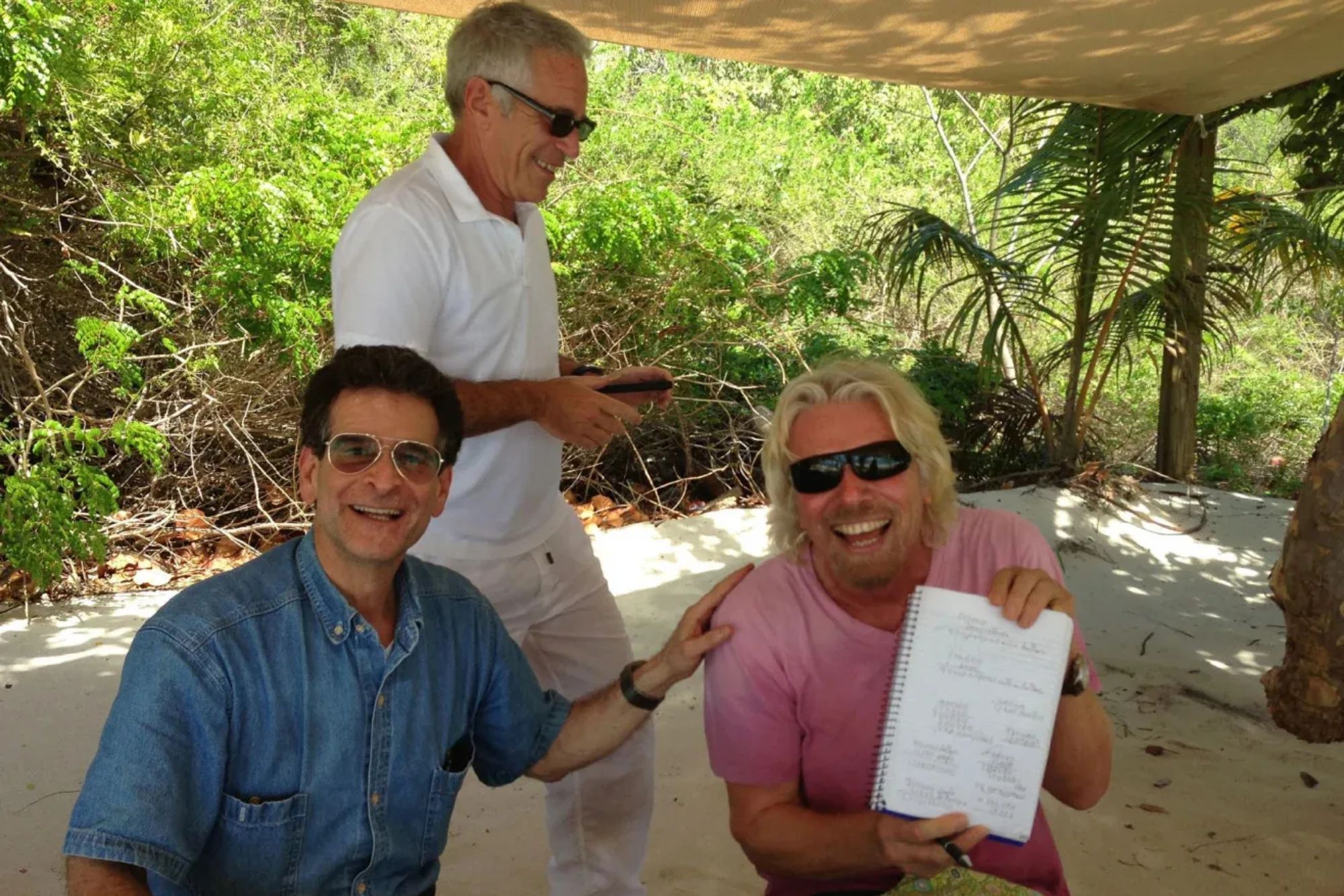 An image collage containing 1 images, Image 1 shows Jeffrey Epstein, Richard Branson, and a third man under a canopy on a beach