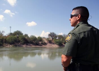 A Border Patrol agent looks out at the Rio Grande River in McAllen, Texas, on Sept. 21, 2016.