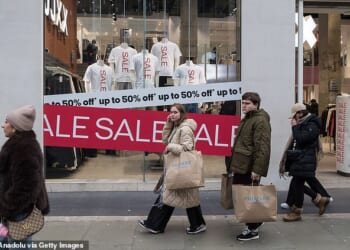 Shoppers walk along Oxford Street during Boxing Day sales in London, United Kingdom on December 26, 2025