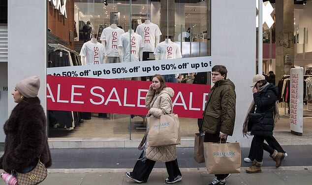 Shoppers walk along Oxford Street during Boxing Day sales in London, United Kingdom on December 26, 2025