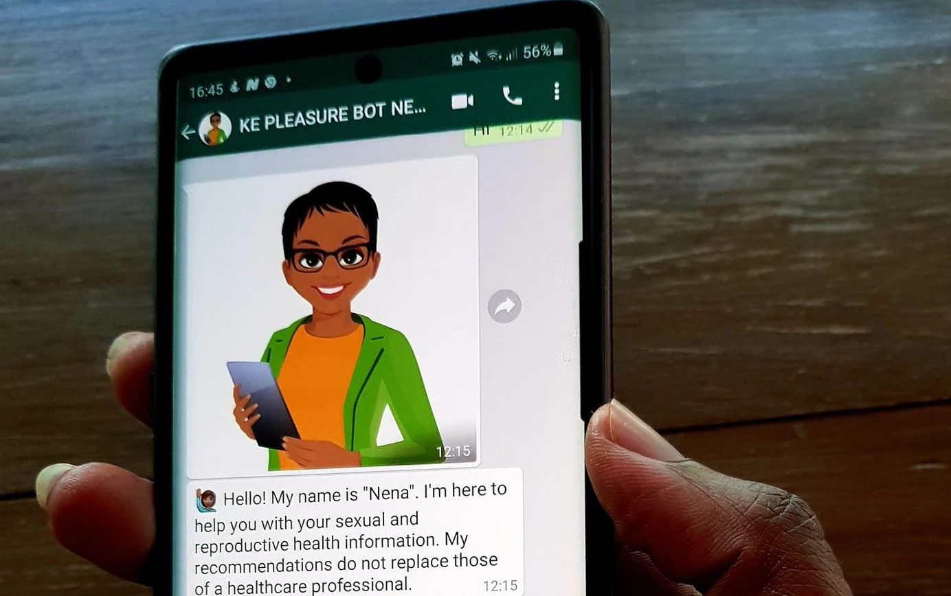 A close-up of a hand holding a phone displaying a chat with "KE PLEASURE BOT NENA", showing a cartoon avatar named Nena and a welcome message.