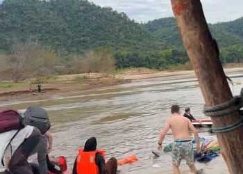 More than a hundred passengers, including British tourists, were left scrambling for their lives when their boat capsized in Laos