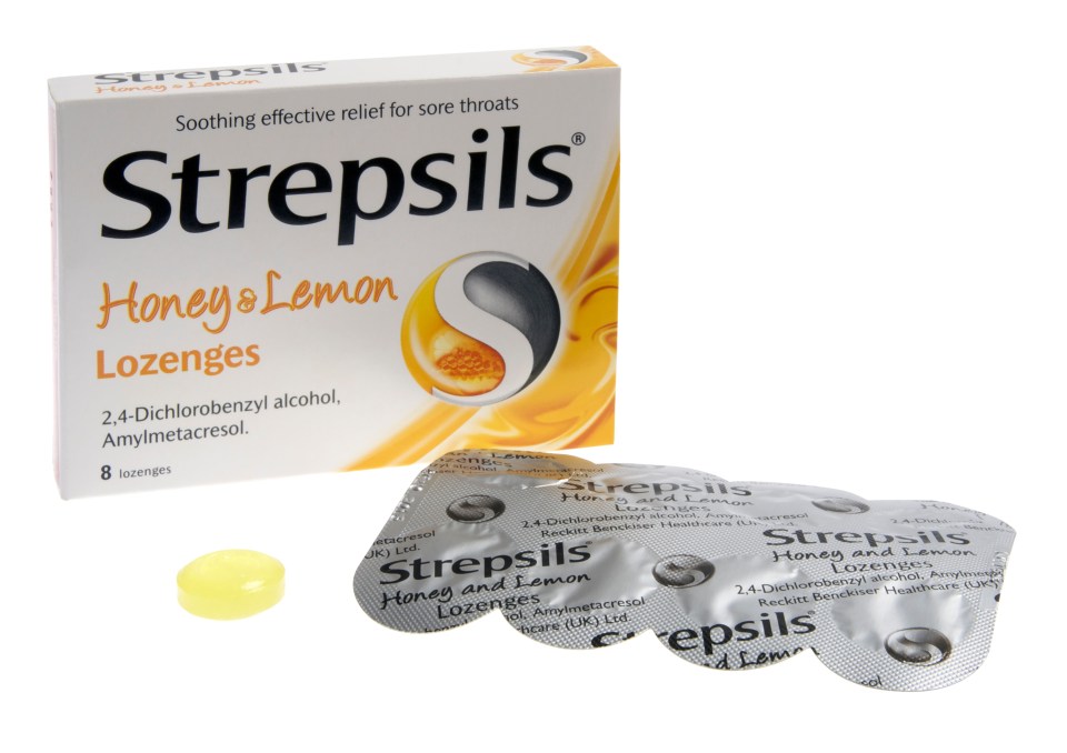 A packet of Strepsils Honey and Lemon lozenges, with a silver blister pack of lozenges and a single yellow lozenge next to it.