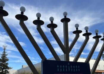 Outdoor menorah display during Hanukkah celebration with a Christmas tree in the background at City Center Bishop Ranch, San Ramon, California, on Dec. 13, 2023.