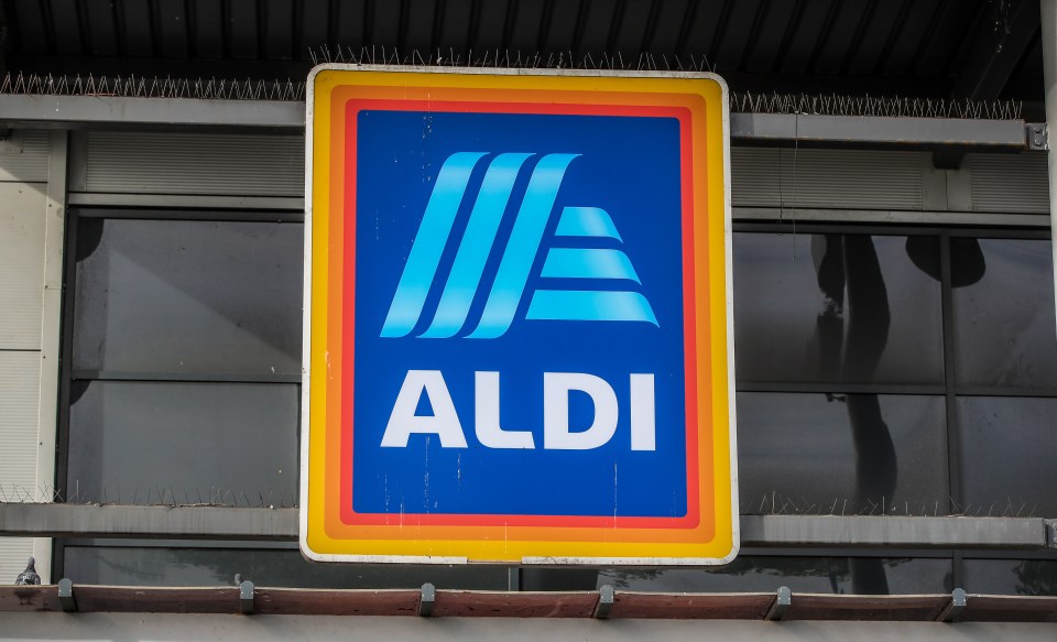 A blue Aldi logo with "ALDI" written in white, on a sign with a red and orange border.