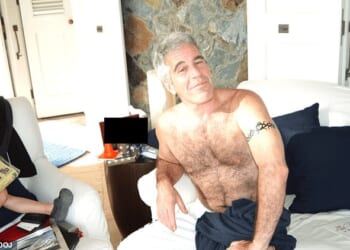 Disgraced financier Jeffrey Epstein is all smiles in the picture as he poses without a shirt and with what appears to be a white towel wrapped around his waist on a couch