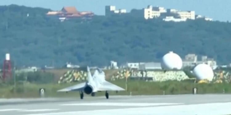 In this image taken off video, a Taiwan fighter jet lands Monday at the Hsinchu Air Base in Taiwan.