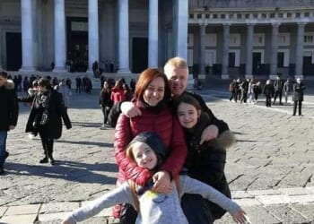 Antonella Di Ielsi, 50, pictured with husband Gianni and her daughter Sara (15, in front of the photo), and her other daughter, 18, who wasn't present at the meal on December 23