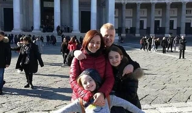 Antonella Di Ielsi, 50, pictured with husband Gianni and her daughter Sara (15, in front of the photo), and her other daughter, 18, who wasn't present at the meal on December 23