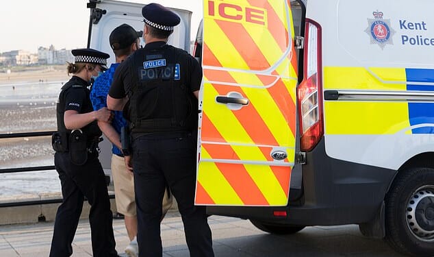 Police abandon investigations into almost four crimes every minute (stock photo of police officers escorting a man in handcuffs)