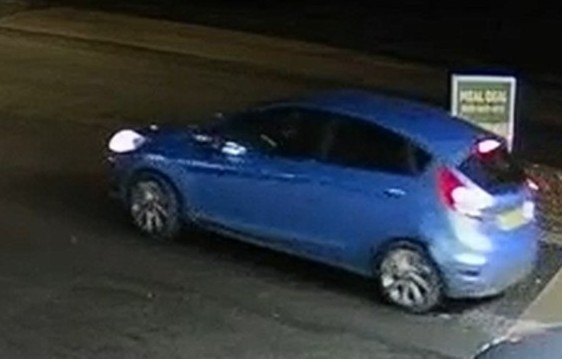 Blue car, possibly a Ford Fiesta, with a "Meal Deal" sign in the background.