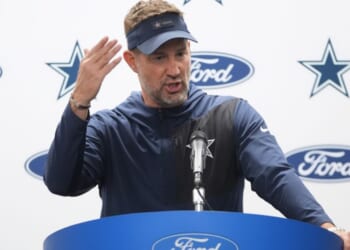 Dallas Cowboys head coach Brian Schottenheimer talks to reporters following Thursday's NFL football game against the Detroit Lions in Detroit.