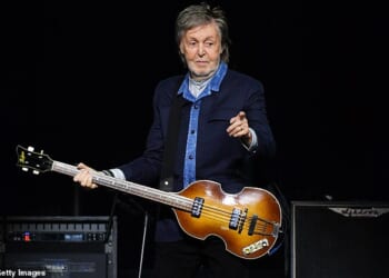 Sir Paul McCartney (pictured in December last year) could face opposition from his neighbour after seeking approval to fell two protected trees at his London home