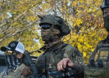 Federal agents searching for illegal aliens pause in a park to regroup on Nov. 6, 2025, in Chicago, Illinois.