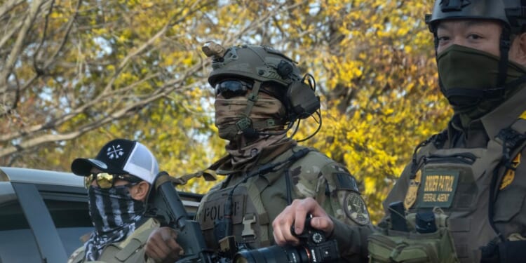 Federal agents searching for illegal aliens pause in a park to regroup on Nov. 6, 2025, in Chicago, Illinois.
