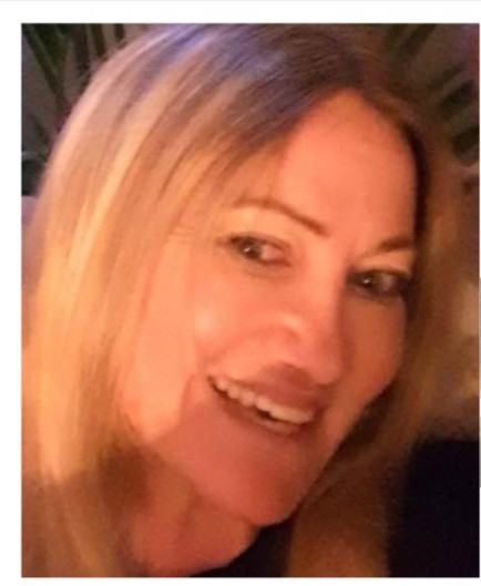 Smiling woman with blonde hair.