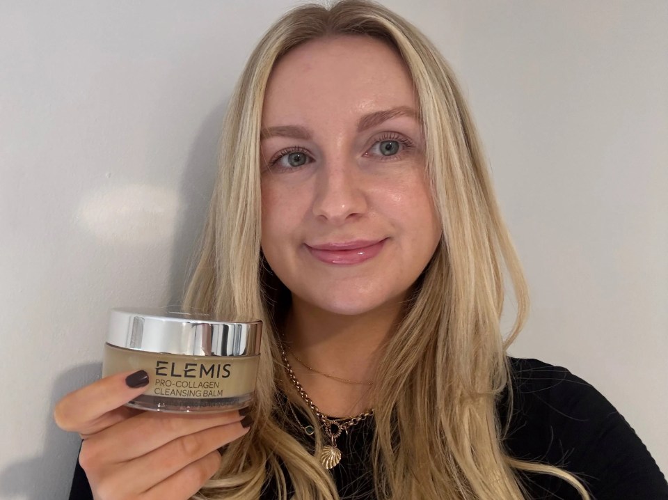 Woman holding Elemis Pro-Collagen Cleansing Balm.