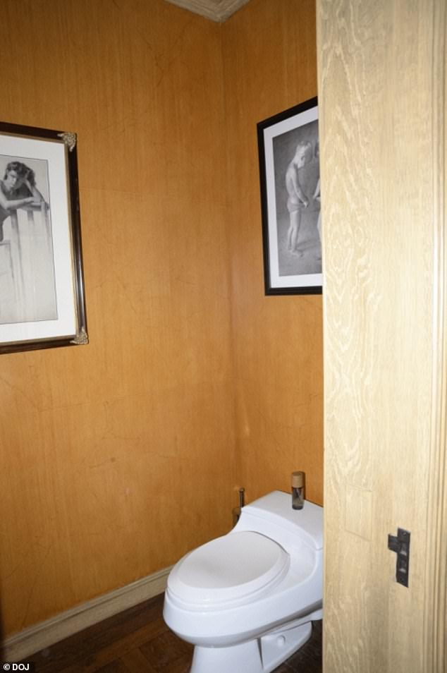 This bathroom has a photo of two young boys looking down into their underwear