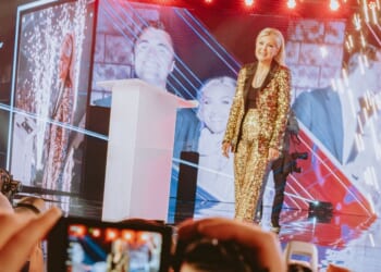 Turning Point USA CEO Erika Kirk walks onstage at AmericaFest in Phoenix, Arizona, on Dec. 18, 2025.