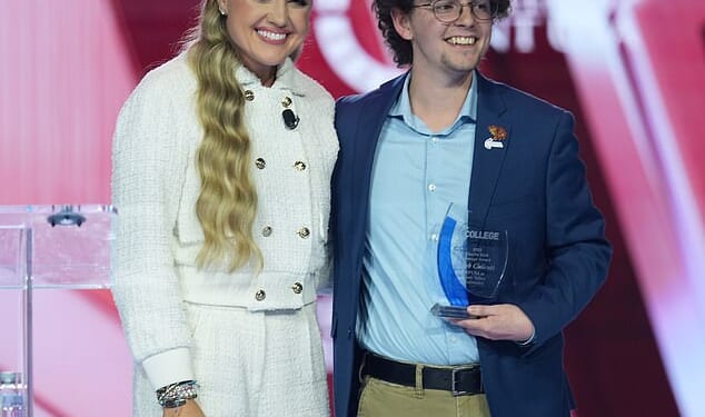 Erika Kirk poses with student Caleb Chilcutt during Turning Point USA's AmericaFest on Saturday